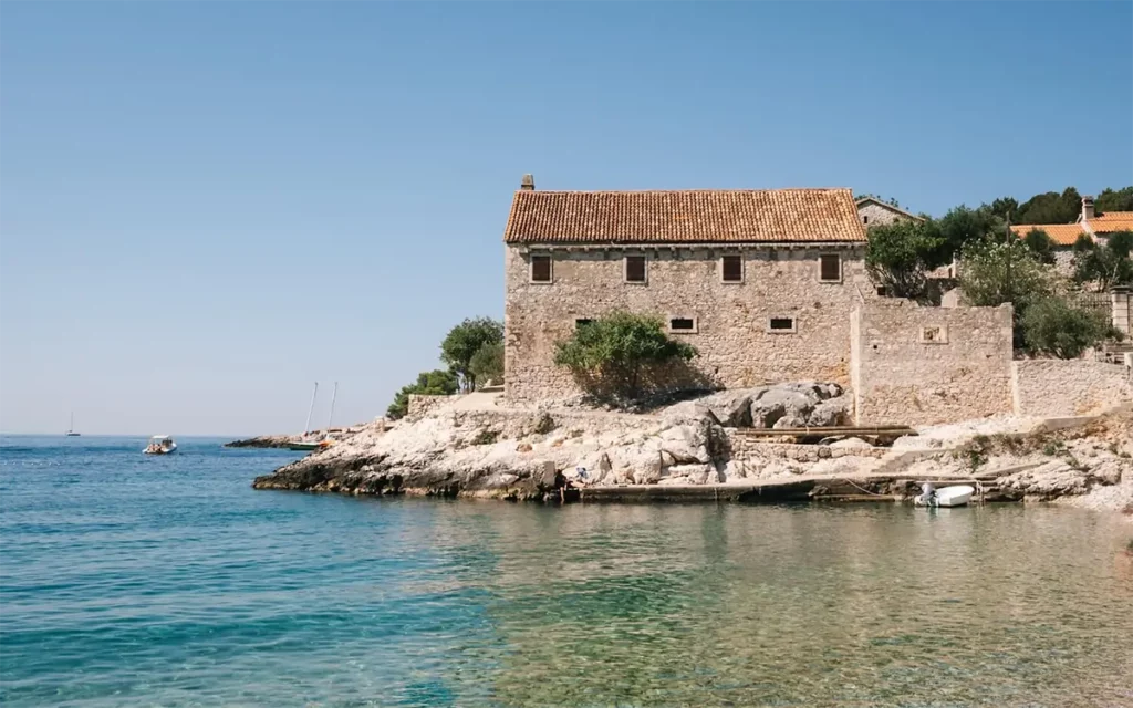 Pebble beach of Dubovica with crystal-clear waters and surrounding cliffs