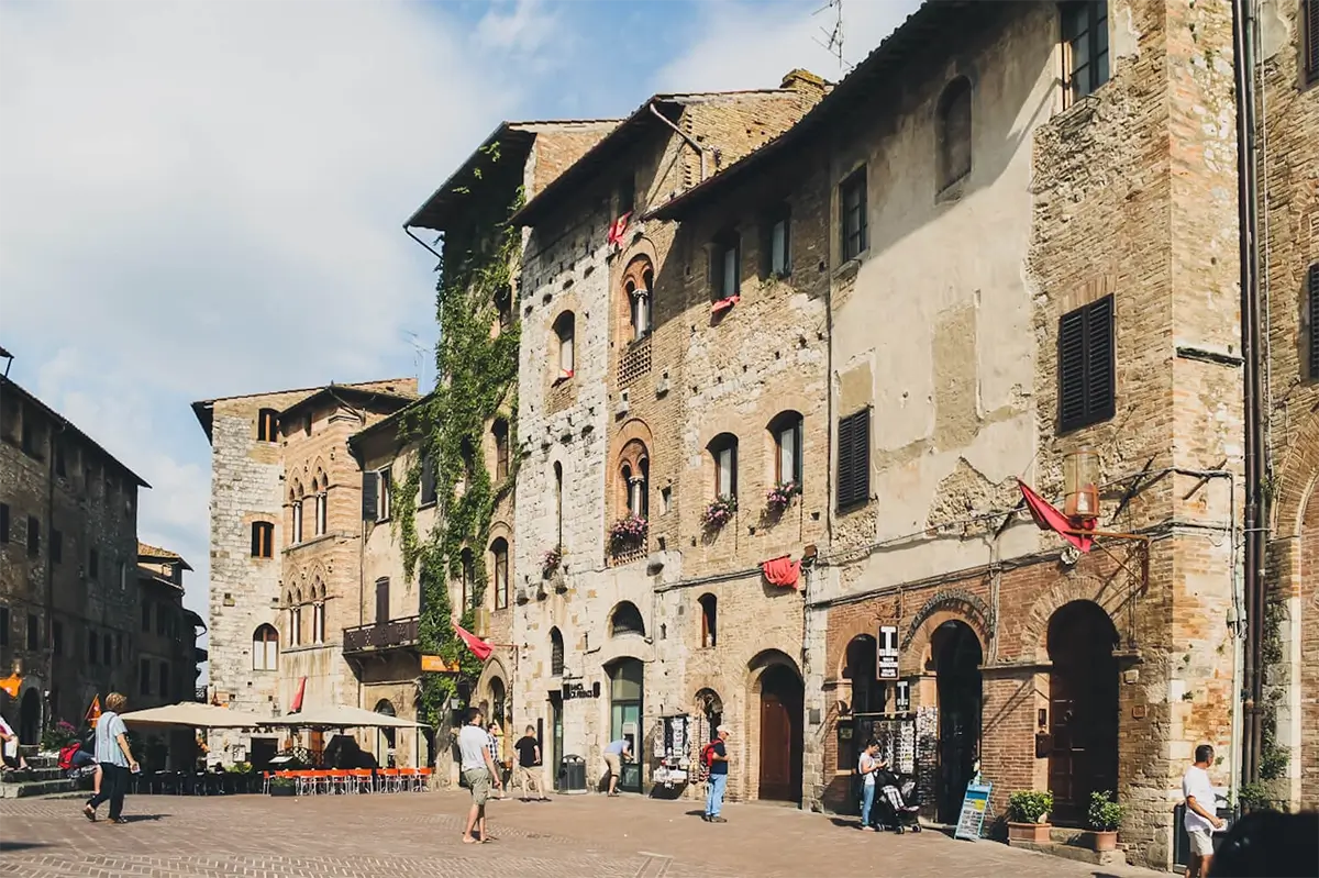 San Gimignano Travel Guide: Best Things to Do and See in Tuscany’s Tower Town 3 Charming medieval street scene in San Gimignano, showcasing historic architecture under a blue sky.