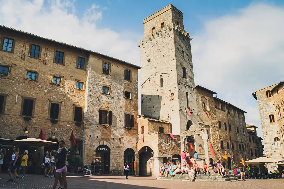 San Gimignano Travel Guide: Best Things to Do and See in Tuscany’s Tower Town 1 Charming medieval street scene in San Gimignano, showcasing historic architecture under a blue sky. San Gimignano travel.