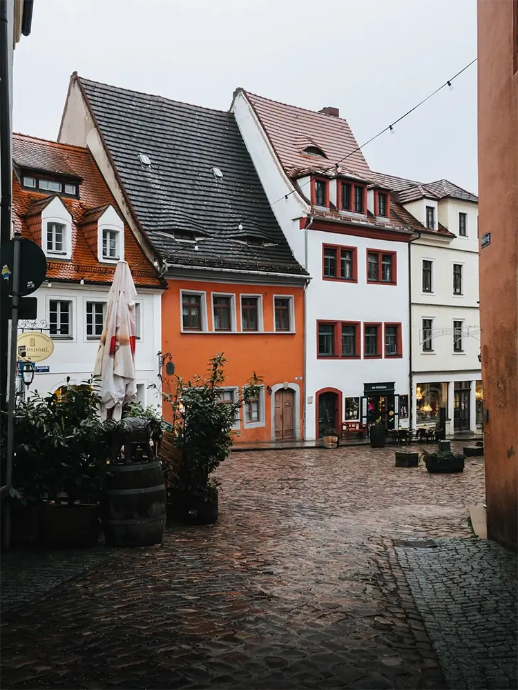 Charming cobblestone street lined with colorful historic houses in Meißen