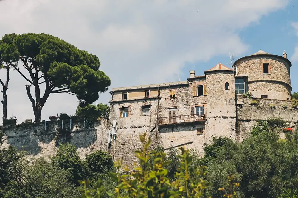 Why Should You Visit Portofino on the Italian Riviera? 4 Historic Castello Brown perched above Portofino surrounded by lush greenery