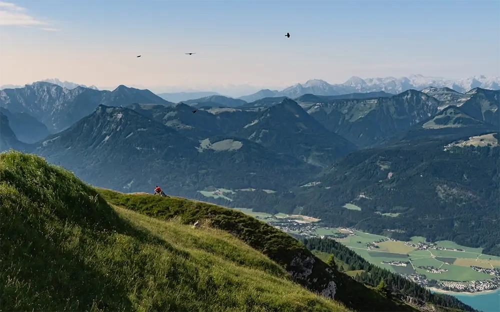Breathtaking 360-degree panoramic view from Schafberg summit showing 13 lakes and Dachstein mountains