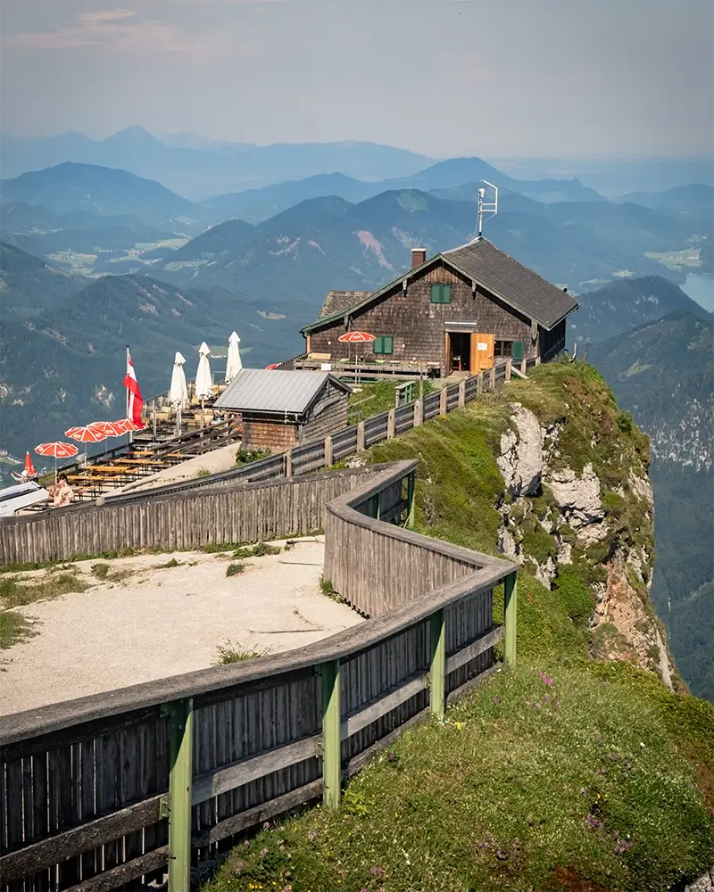 "Breathtaking 360-degree panoramic view from Schafberg summit showing 13 lakes and Dachstein mountains